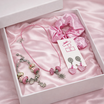 Jewelry set including a bracelet, earrings, and a scrunchie in a white box.