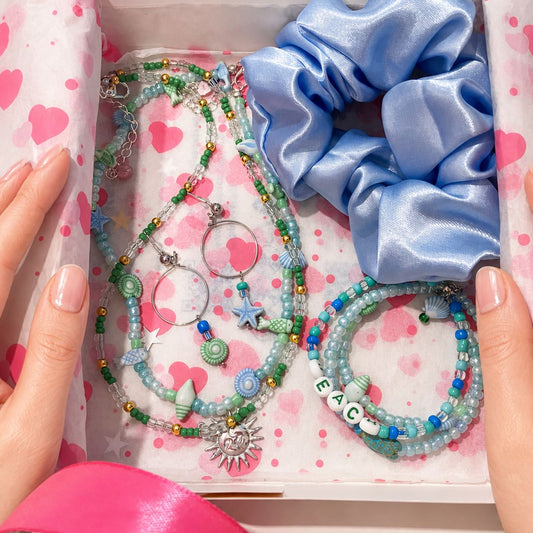 Gift box with jewelry and satin hair scrunchie