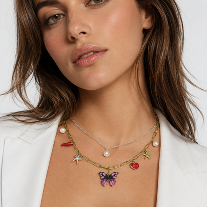 Gold and silver layered necklace with charms.