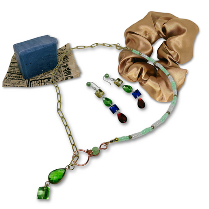 Set includes mint detox refreshing soap, beaded and gold chain necklace, dangling earrings and gold satin scrunchie.