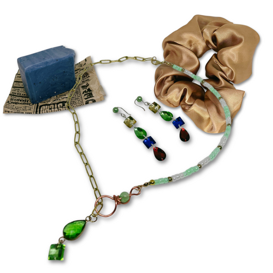 Set includes mint detox refreshing soap, beaded and gold chain necklace, dangling earrings and gold satin scrunchie.