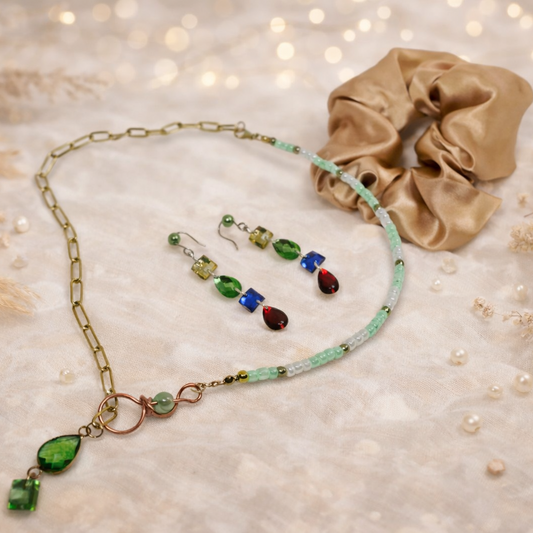 Set includes beaded and gold chain necklace, dangling earrings and gold satin scrunchie.