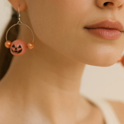 Halloween themed orange pumpkin earrings.