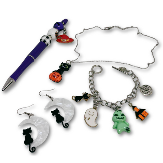Set of Halloween-themed jewelry including a pen, necklace, earrings, and bracelet with various charms.