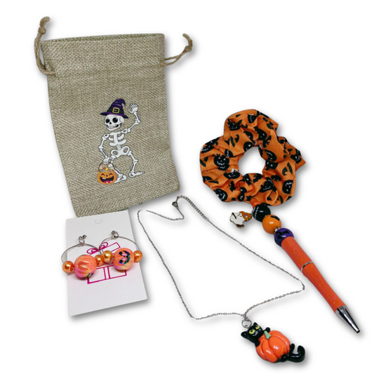 Gift set includes, silver necklace, pumpkin earrings, pen, hair scrunchie, bag and gift box.