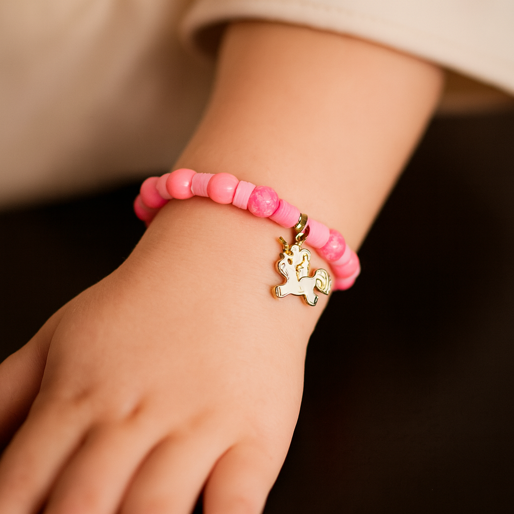 Pink beaded bracelet with a unicorn charm.