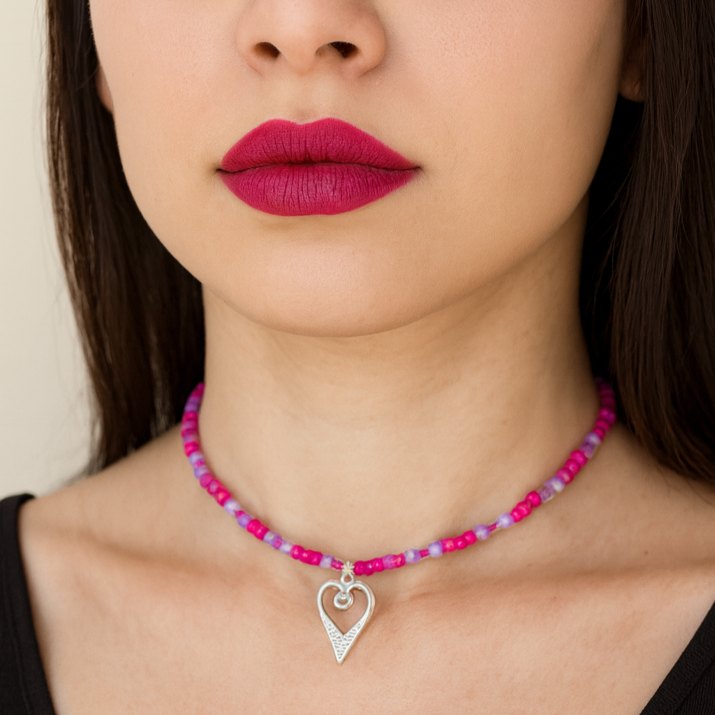 Pink beads necklace with silver heart pendant.