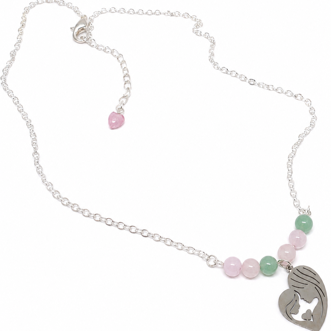 A silver chain necklace featuring a heart-shaped pendant with a mother-and-child silhouette, accented by pink and green beads.
