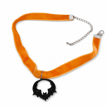 Orange velvet choker with black bat pendant.