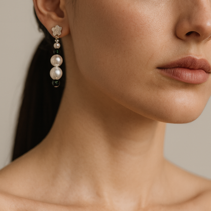 Pearl earrings with small dark green beads. 
