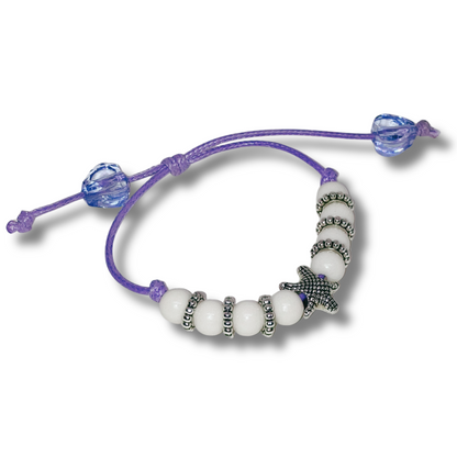 Bracelet with white beads and purple cord 