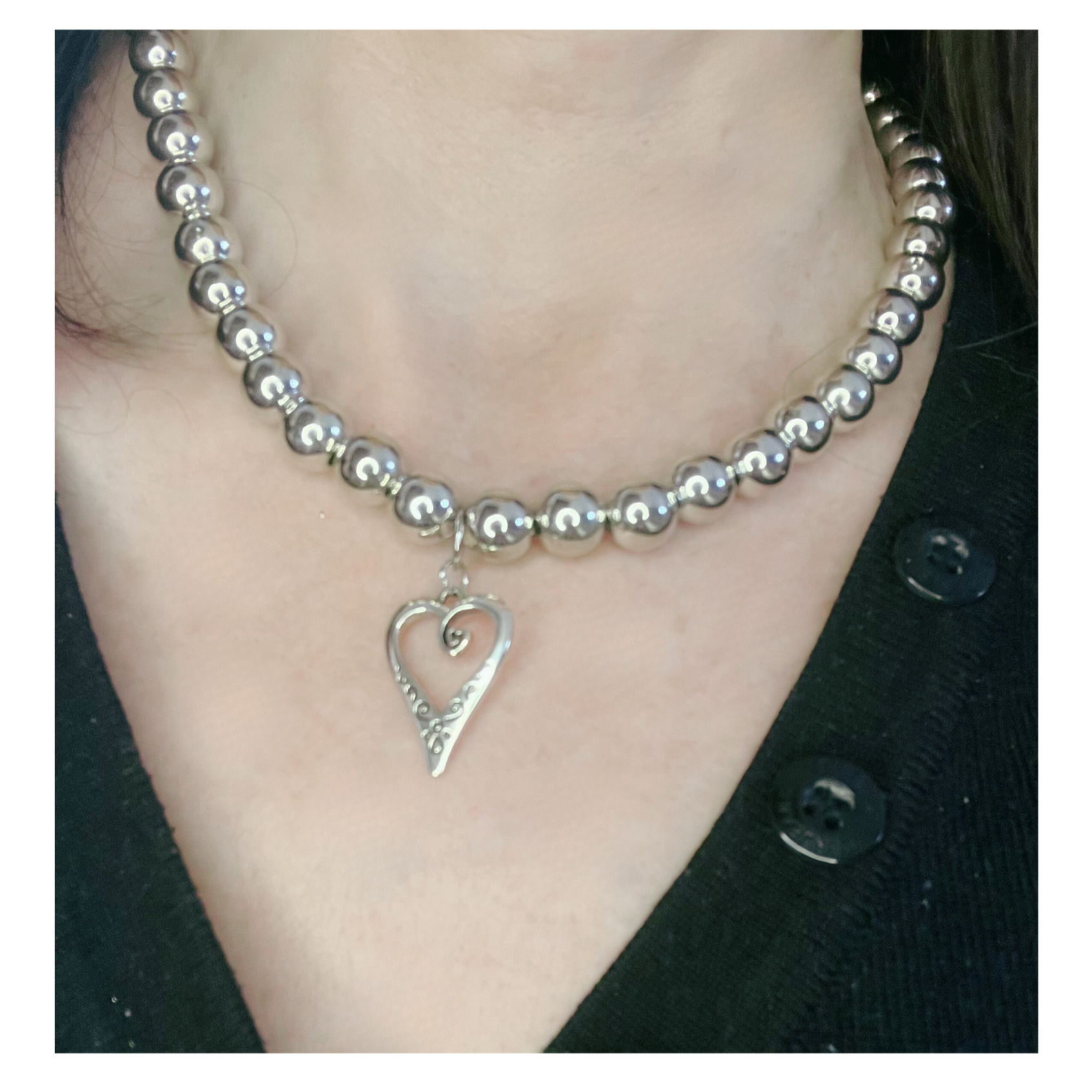 Silver beads necklace with heart.