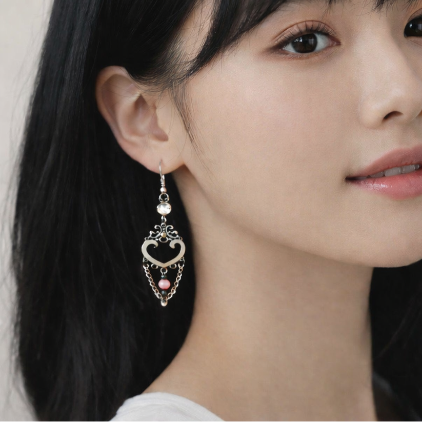 Silver dangling earrings with pink bead