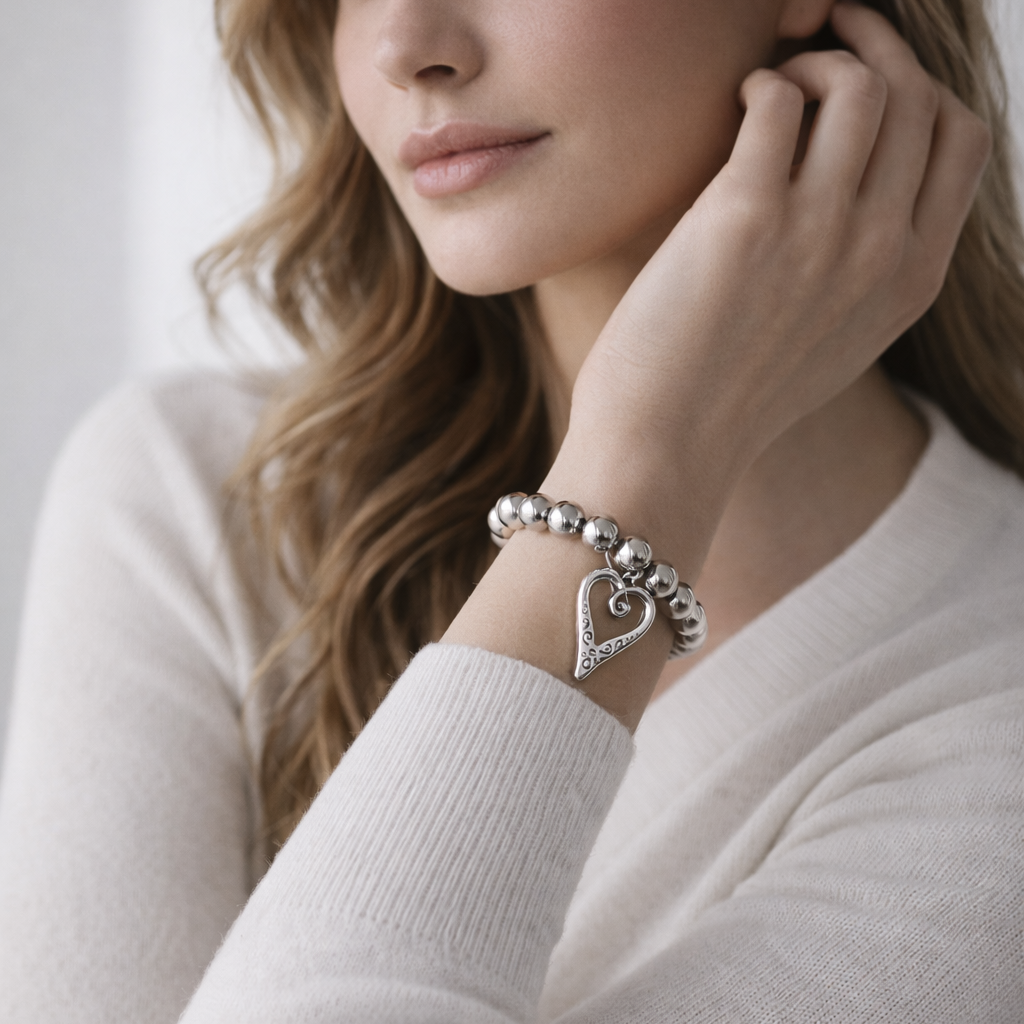 Silver beads bracelet with heart pendant.