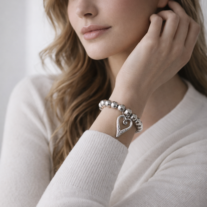 Silver beads bracelet with heart pendant.