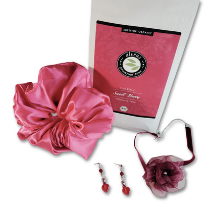 A luxurious berry themed jewelry gift set for women, featuring a rose necklace, organic herbal tea, earring and satin scrunchie. Perfect for self-care and relaxation.