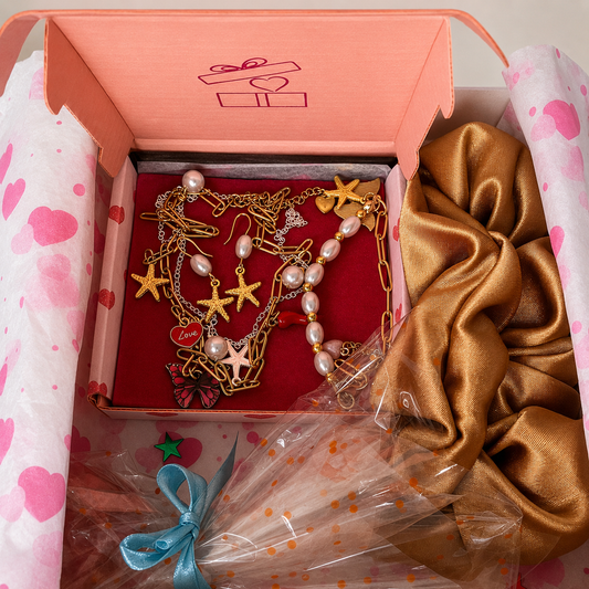 Gift box with jewelry inside, plus hair scrunchie and free gift.