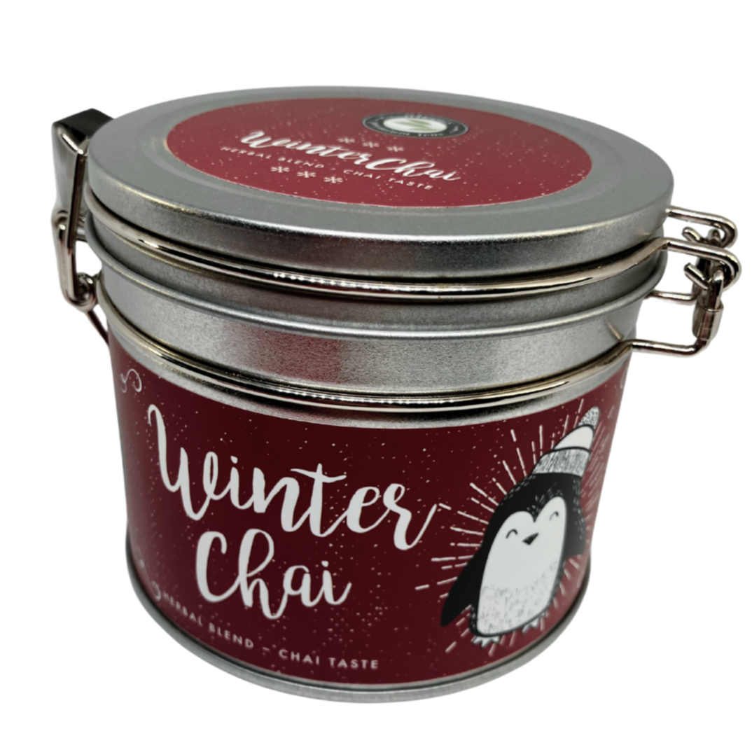 A decorated round silver tin containing Christmas chai tea.