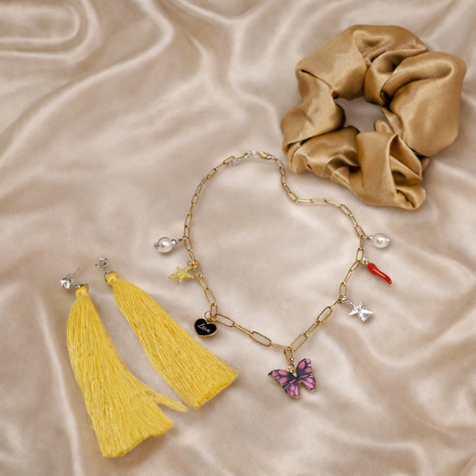 Imitation gold chain necklace with multiple charms (including a butterfly, chili, star, and pearl)
Yellow tassel earrings (pierced)
Gold satin hair scrunchie