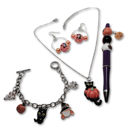 Halloween Pumpkin Perfection Gift Set showcasing pumpkin earrings and black cat pumpkin necklace with an adorned bracelet and pen