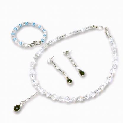 Jewelry set with necklace, bracelet, and earrings.