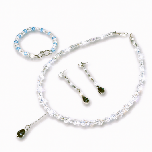 Jewelry set with necklace, bracelet, and earrings.