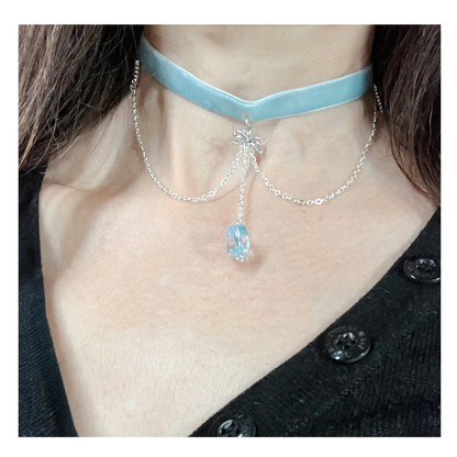 Wearing blue velvet necklace choker with silver chain and an ice crystal bead.